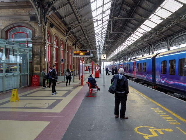 Platform 3 at Preston railway station, with a train at the platform