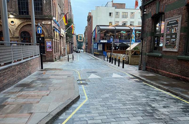 A brick street in Liverpool Ropewalks in daylight, with the MODO sign